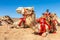 Harnessed riding camels resting in the desert, Al Ula, Saudi Arabia