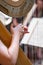 harp on symphony orchestra stage, detail of hands with strings