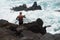 Harpoon spear fisherman at rocky shore