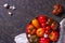 The harvest of assorted tomatoes. Colorful organic tomatoes on a large dish. Tomatoes different varieties.