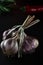 Harvest. A bunch of garlic lies on a black background close-up