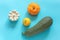 Harvest of colored different vegetables gourds pumpkin, zucchini, pattypan squash on blue background. Top view Flat lay