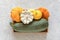 Harvest colored different vegetables gourds pumpkin, zucchini, squash in a wooden box on gray stone background. Top view Flat lay