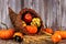 Harvest cornucopia on a rustic wood background