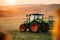 Harvest details with tractor and trailer transporting harvest at sunset. Agriculture industry machinery