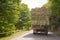 After the harvest. Early autumn. The truck is carrying hay. hay carrier at the interurban road . The truck carries rolls of hay