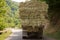 After the harvest. Early autumn. The truck is carrying hay. hay carrier at the interurban road . The truck carries rolls of hay