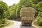 After the harvest. Early autumn. The truck is carrying hay. hay carrier at the interurban road . The truck carries rolls of hay