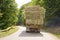 After the harvest. Early autumn. The truck is carrying hay. hay carrier at the interurban road . The truck carries rolls of hay