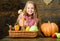 Harvest festival concept. Farm market fall harvest. Child girl presenting harvest of her vegetable garden on wooden