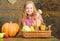 Harvest festival concept. Farm market fall harvest. Child girl presenting harvest of her vegetable garden on wooden