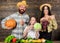 Harvest festival concept. Parents and daughter celebrate harvest holiday pumpkin vegetables fruits. Family farmers with