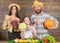 Harvest festival concept. Parents and daughter celebrate harvest holiday pumpkin vegetables fruits. Family farmers with