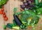 Harvest of fresh vegetables on wooden background. Top view. Potatoes, carrot, squash, peas, tomatoes