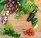 Harvest of fresh vegetables on wooden background. Top view. Potatoes, carrot, squash, peas, tomatoes