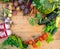 Harvest of fresh vegetables on wooden background. Top view. Potatoes, carrot, squash, peas, tomatoes