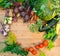 Harvest of fresh vegetables on wooden background. Top view. Potatoes, carrot, squash, peas, tomatoes