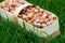 Harvest of hazelnuts in a wicker basket made of birch bark on the green grass