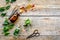 Harvest medicinal herb. Leaves, bottles and sciccors on wooden background top view copyspace