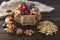 Harvest of ripe apples, plums, grapes in vintage basket on wooden background and burlap. A