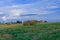 Harvest season concept scenic view agriculture field with stack of hay in peaceful and calm evening clear weather time in