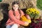 Harvest season. small girl big pumpkin. ready for halloween. autumn time. cheerful kid dried flower. fall composition