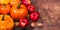 Harvest or Thanksgiving background with pumpkins, apples and fallen leaves on wooden background with copy space for text. Hallow