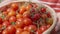 The harvest of tomatoes. Hands holding basket of ripe red fruits.