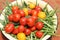 Harvest of vegetables: red and yellow tomatoes, cucumbers, green onions in containers