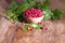 The harvest of wild raspberries in a wicker basket. Berry summer background