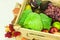 Harvest in wooden box and fallen leaves. Autumn products - cabbage, apples, pears, grape, turnip, kohlrabi and bunch of guelder ro