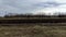 Harvested agricultural field and farm in the winter without snow