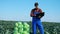 Harvested cabbage and an agriculturist observing it