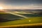 Harvested fields Use a narrow aperture for a starburst effect around the sun Soft made with generative ai