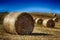 Harvested landscape with straw bales between fields