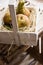 Harvested ripe conference pears on straw in vintage wood box, by window, natural soft light