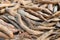 Harvested ripe pods of kidney bean on heap. Pile of dry raw pods of haricot plant Phaseolus vulgaris as natural background.