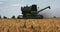 The harvester collects the crop in the field