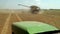 The Harvester Collects The Crop, The Tractor Goes To The Combined View From The Cabin Of The Tractor. Summer Heat During