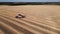 harvester collects wheat from the fields. 4k drone footage