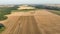 Harvester combine drone aerial view during harvesting harvest tractor of cereals wheat cuts crop Triticum aestivum field