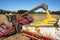 Harvester combine dumping corn into grain cart on back of tractor