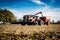 Harvester combine offloading grain into a wagon during soybean harvest in Illinois