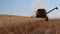 Harvester combine thrash wheat field