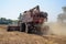 A harvester cutting dried, ripened soybeans on a family farm