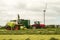 Harvester cutting field, loading Silage into a Tractor Trailer