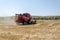 The harvester is harvesting the wheat field.