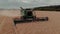 Harvester machine to harvest wheat field working. Combine harvester agriculture machine harvesting golden ripe wheat