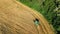 Harvester machine working in field aerial view from above, combine harvester agriculture machine harvesting ripe wheat field