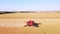 Harvester machine working in wheat field aerial view.